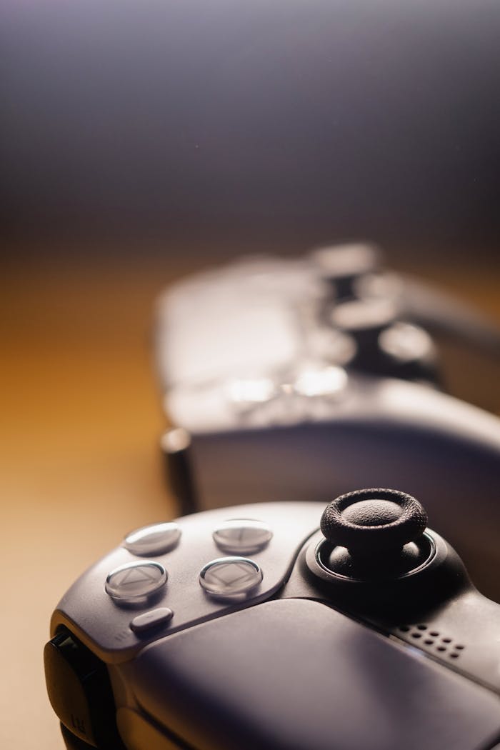 Crafting Captivating Headlines: Your awesome post title goes here Focused view of sleek game controllers with warm lighting. Ideal for gaming concepts.